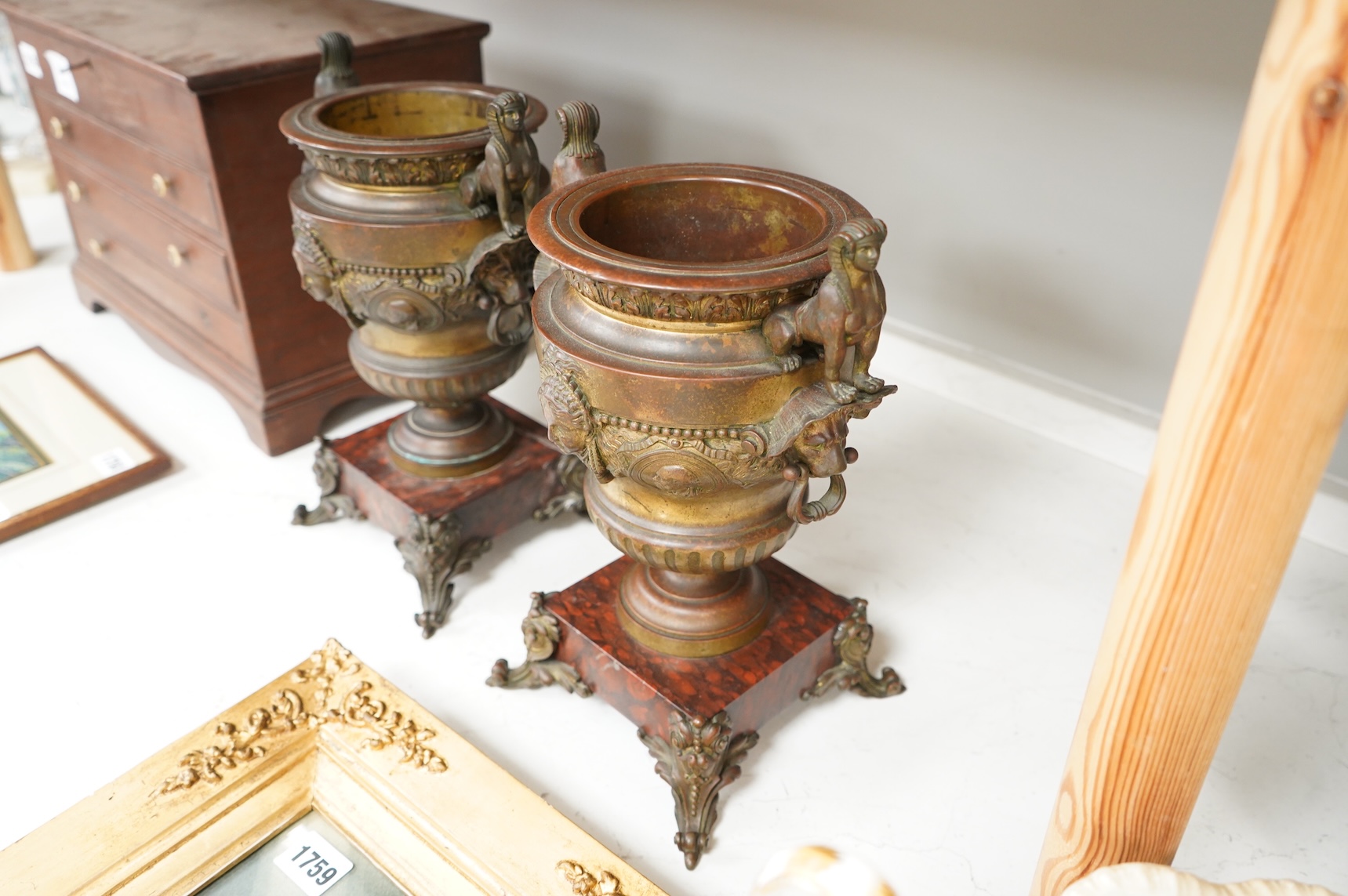 A pair of late 19 century French Egyptian revival bronze and rouge marble urns, 31cm high